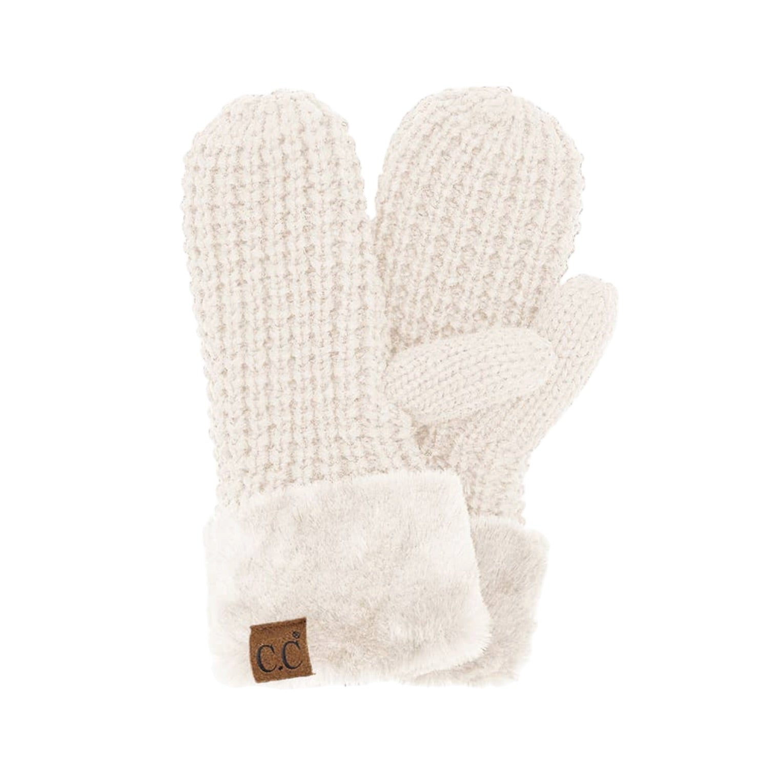 A pair of cream-colored knit mittens with a soft faux-fur cuff and a small brown leather patch featuring the initials 'CC'.