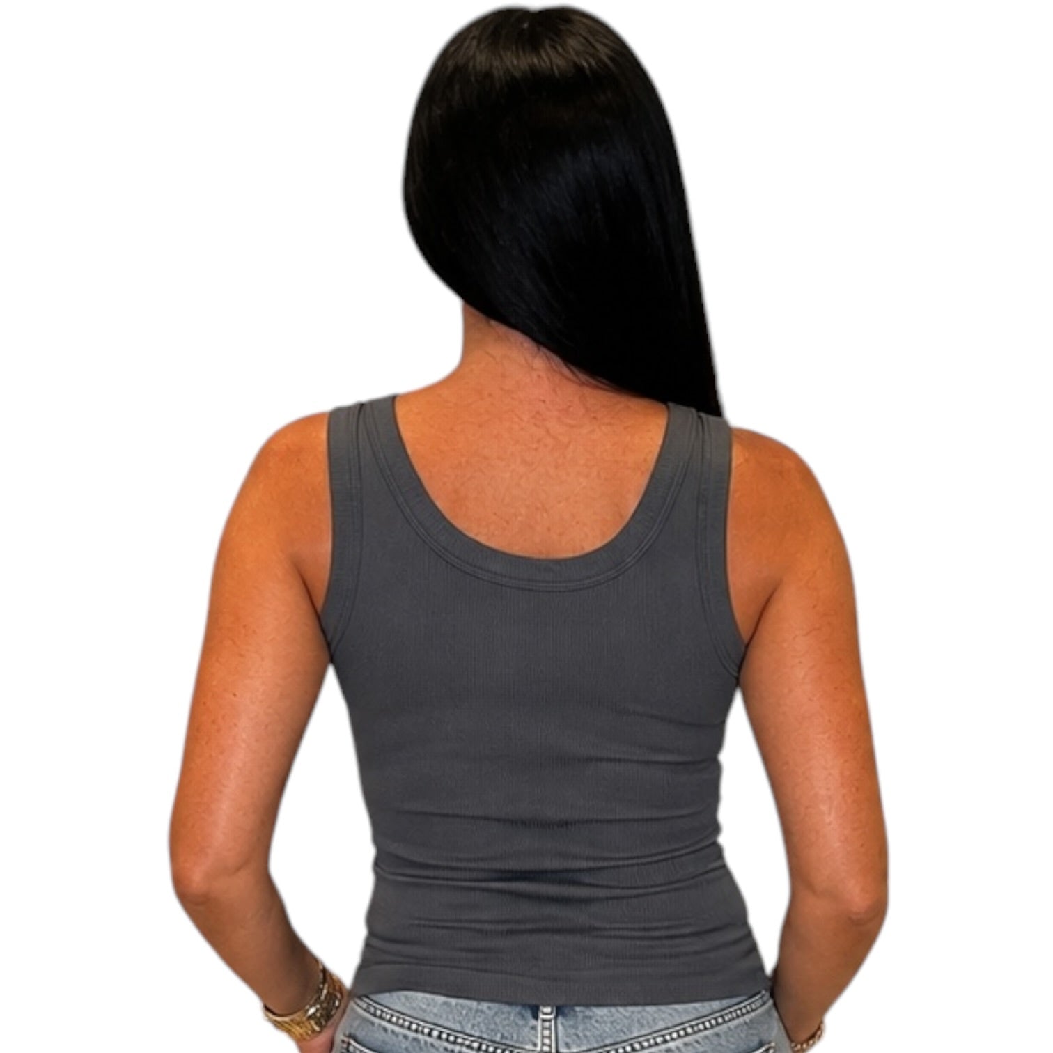 A woman shown from the back wearing a dark gray sleeveless tank top and light blue jeans, isolated on a white background.