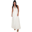 Woman wearing a white halter neck dress on a white background