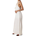 Woman wearing a white halter neck dress on a white background