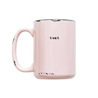 Pink mug with 'twat' printed on it against a white background