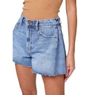 Denim shorts worn by a person on a white background