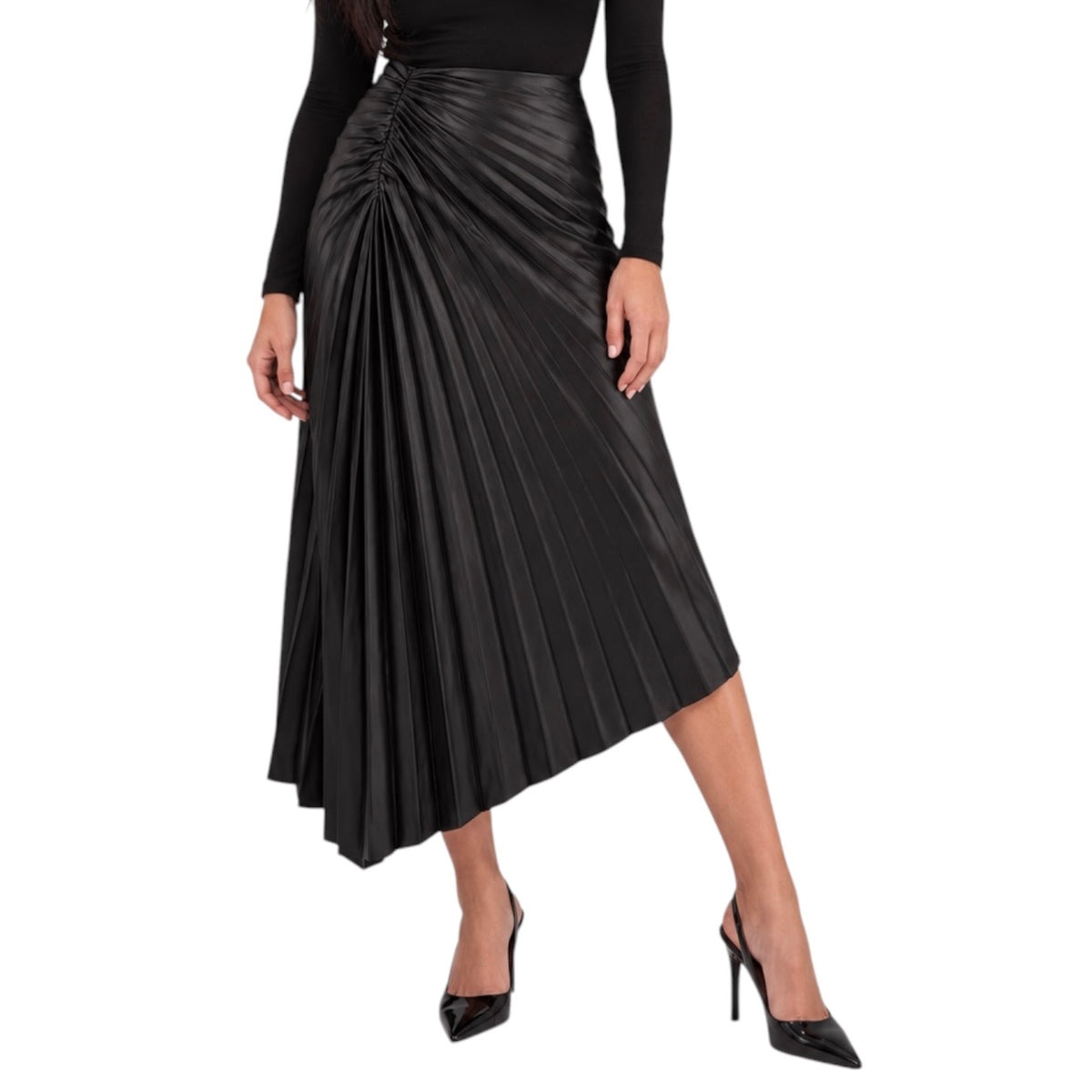 A black pleated midi skirt with a ruched waist, worn by a model in a black long-sleeve top and black pointed-toe heels against a plain white background.