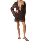 Woman wearing a brown sequin dress on a white background