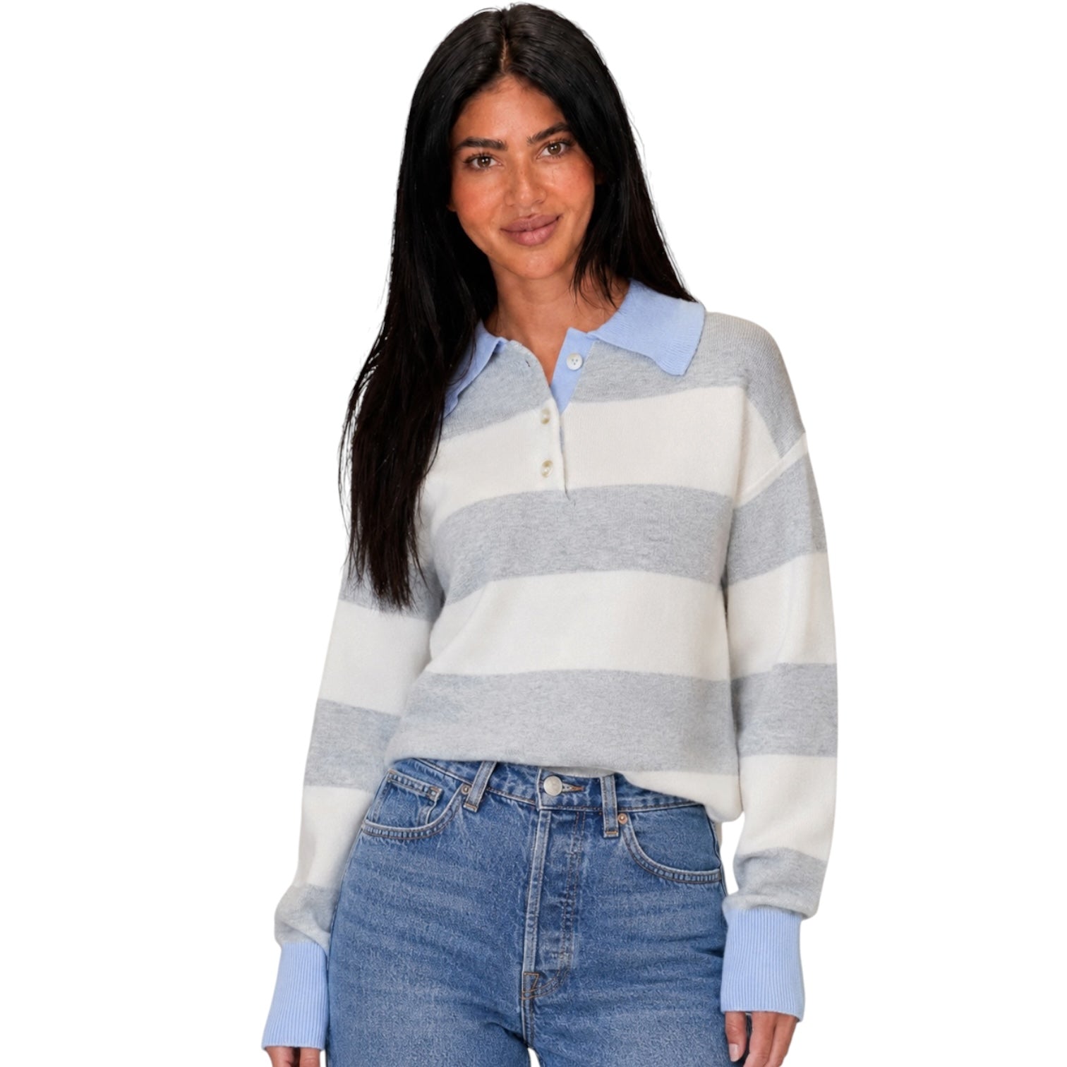 A woman modeling a light blue and white striped knit polo sweater with a light blue collar and cuffs, paired with blue jeans, against a plain white background.