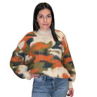 Woman wearing a multicolored sweater with a white background