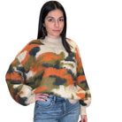 Woman wearing a colorful sweater with a white background