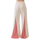 Beige pants with red striped sides on a white background