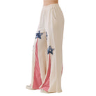 Beige pants with blue star and red stripe design on a white background