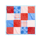 Patchwork quilt with red, blue, and white patterns on a white background