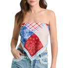 Woman wearing a strapless top made of bandana fabric on a white background