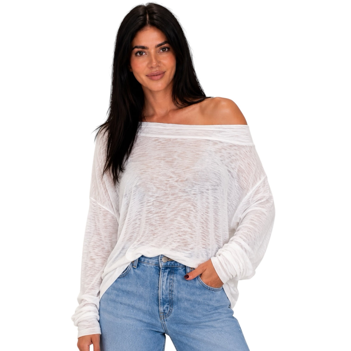 A woman modeling a white off-the-shoulder long-sleeve top with a textured, slightly sheer fabric, paired with light blue jeans, against a solid white background.