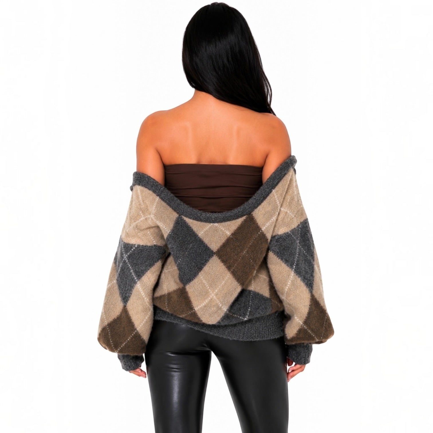 A woman shown from the back wearing a beige, brown, and gray argyle sweater draped off her shoulders, paired with a dark brown bandeau top and black pants, against a plain white background.