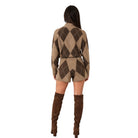 A woman shown from the back wearing a beige and brown argyle knit cardigan and matching shorts, paired with brown over-the-knee boots, against a plain white background.