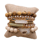 Set of beaded and crystal bracelets on a textured surface