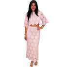 Woman wearing a pink lace outfit on a white background
