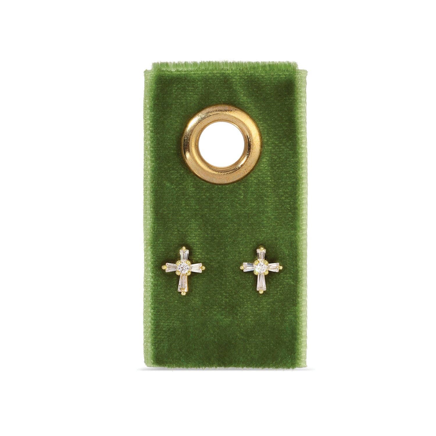 Gold cross earrings on a green velvet card with a gold ring