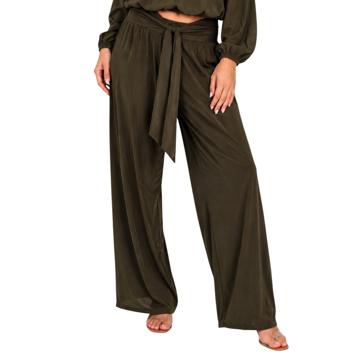 A person wearing loose, wide-leg olive green pants with a tied waist and a matching long-sleeve cropped top, shown against a plain white background.