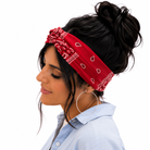 Woman wearing a red bandana headband with white patterns on a white background