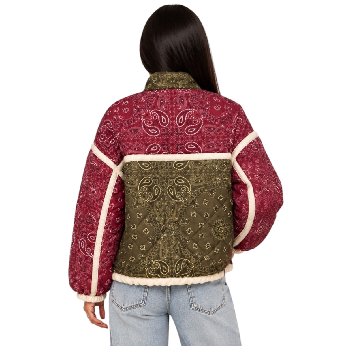 A woman viewed from the back wearing a cropped patchwork jacket with red paisley bandana panels, an olive green center panel, and cream sherpa lining, paired with light blue jeans against a white background.