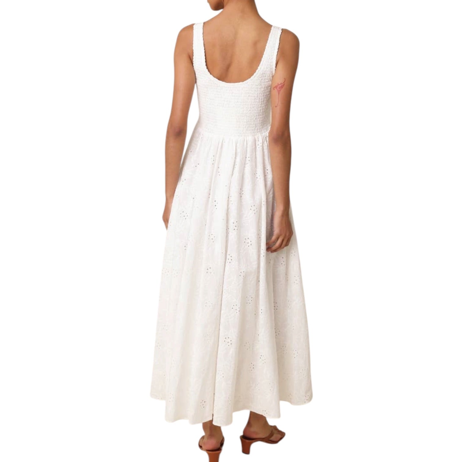 White sleeveless dress worn by a person on a white background