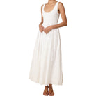 White sleeveless dress worn by a person on a white background
