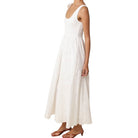 White sleeveless dress worn by a person on a white background
