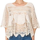 woman wearing crochet top on white background