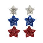 Star-shaped earrings in red, white, and blue on a white background