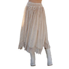 Beige lace skirt with white boots on a white background