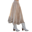 Beige lace skirt with white boots on a white background