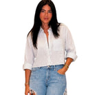 Woman wearing a striped shirt and jeans on a white background