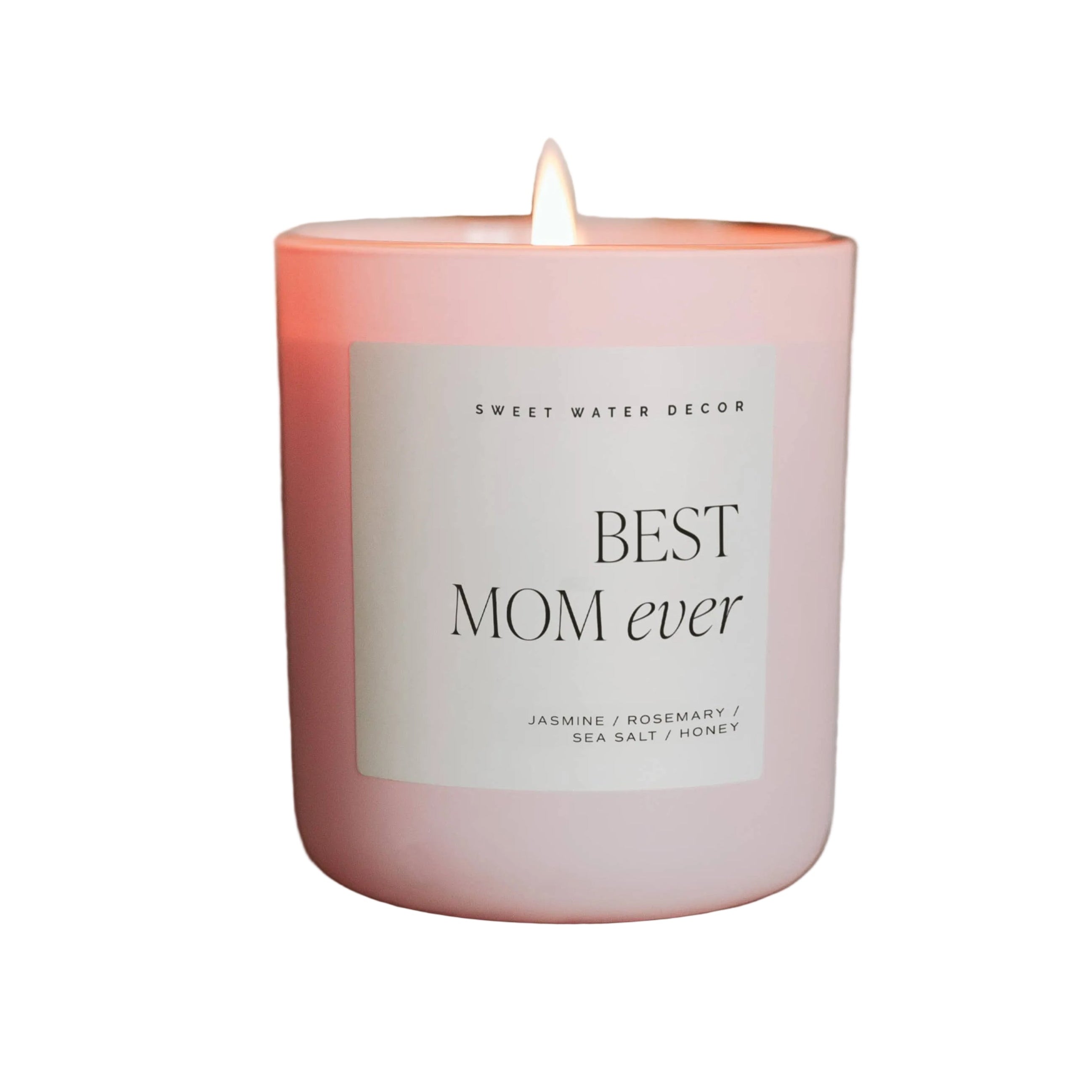 Pink candle labeled 'Best Mom Ever' on a stone block with a blurred floral background