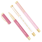 Two pink pens with gold accents and motivational text on a white background