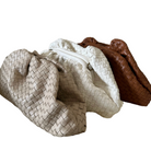 Three woven bags in beige, white, and brown on a white background.