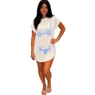 Woman wearing a white tee with blue shell designs on a white background