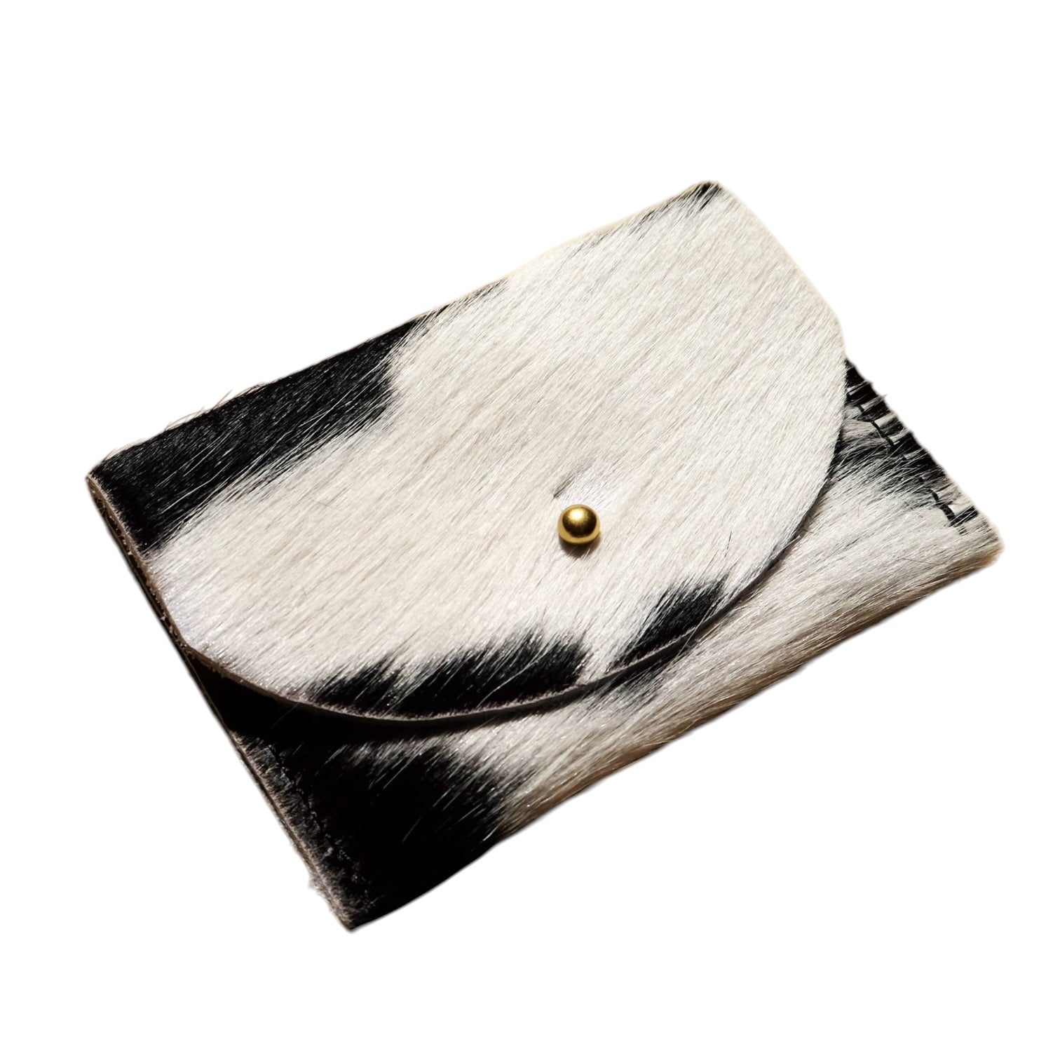 A small black and white cowhide envelope-style cardholder with a gold snap button, shown on a plain white background.