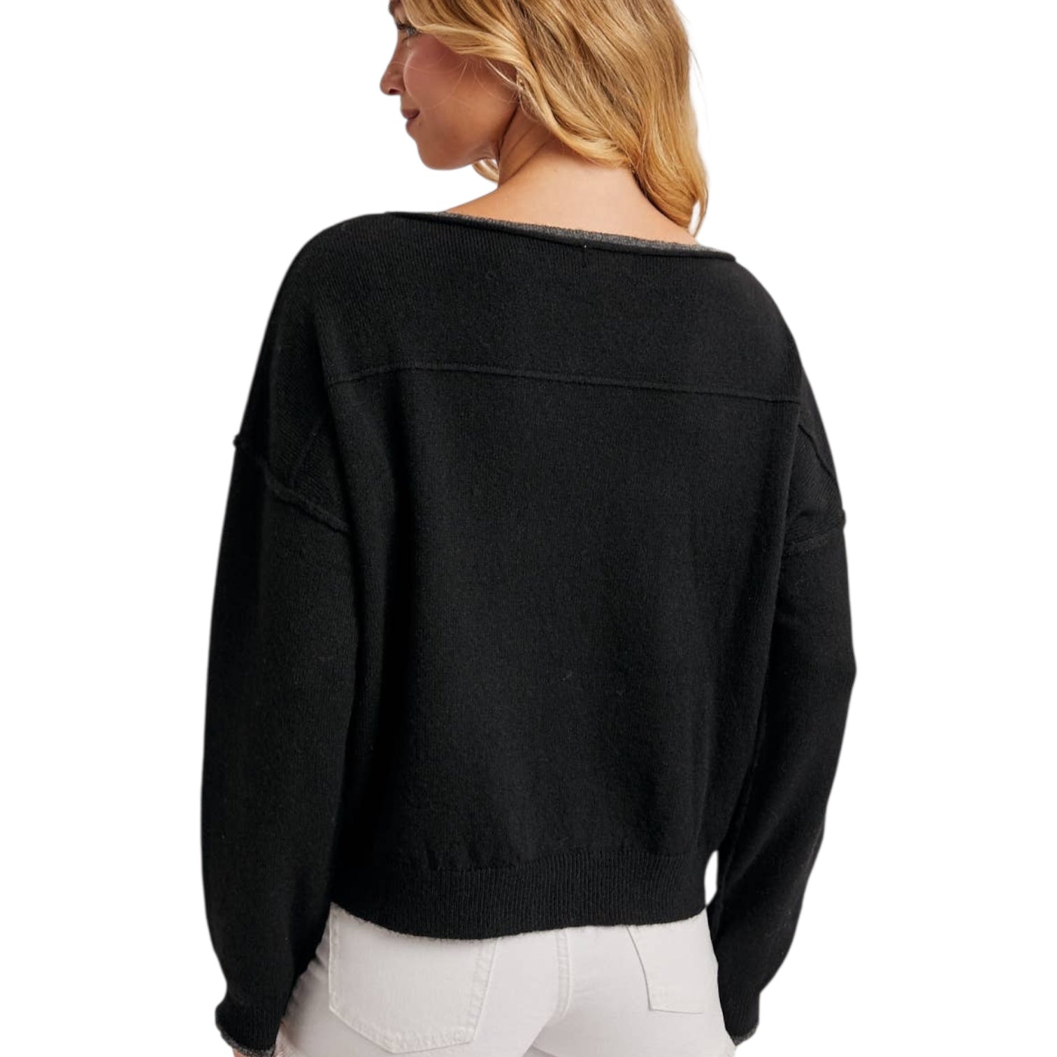 Black sweater worn by a person on a white background