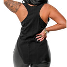 Person wearing a black sleeveless top and black pants on a white background