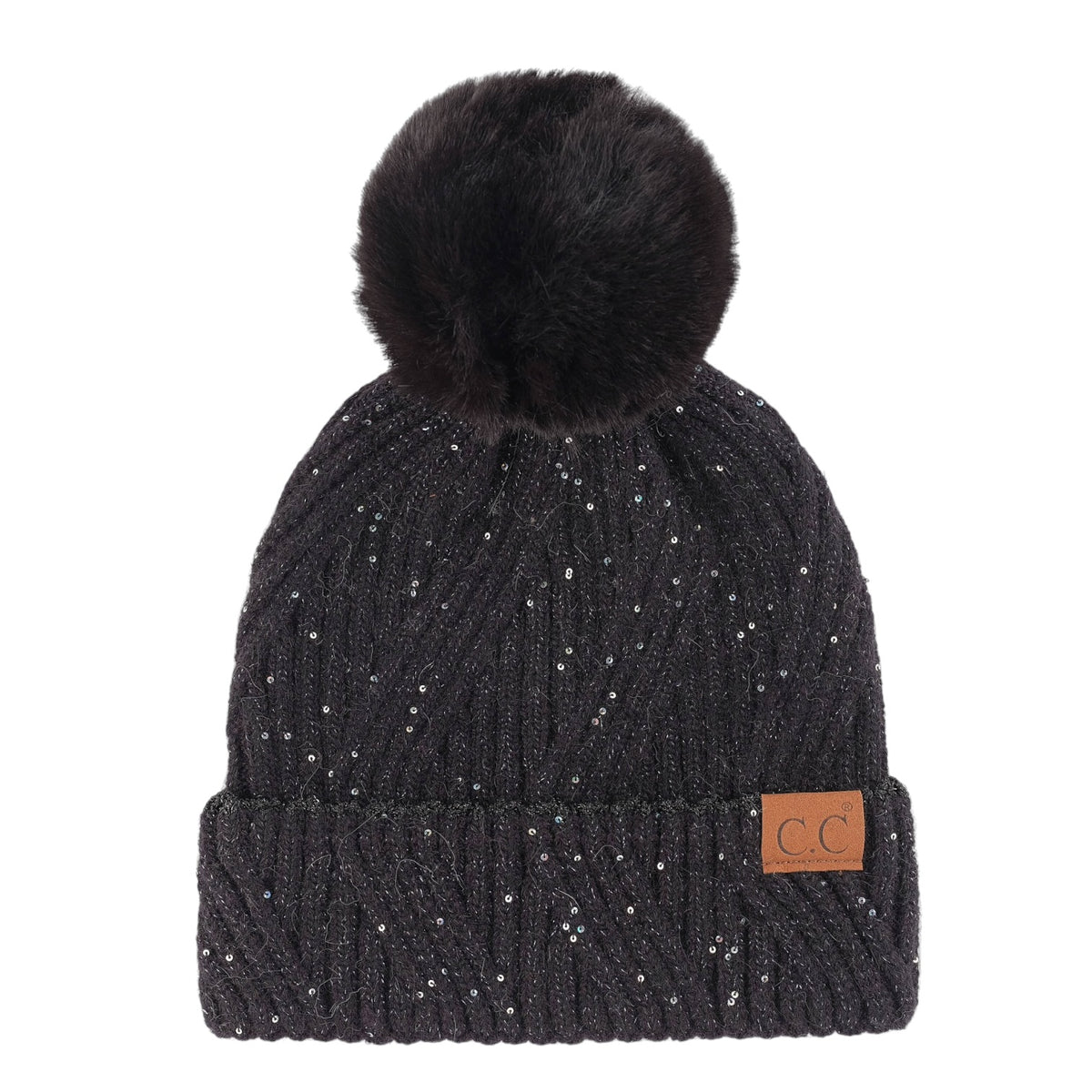 A black ribbed knit beanie hat with a fluffy black faux fur pom-pom on top, decorated with tiny silver glitter specks, featuring a small brown leather patch with 'CC' on the folded cuff.