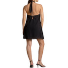 Black halter neck dress worn by a model on a white background