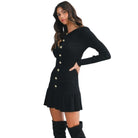 Woman wearing a black dress with gold buttons on a white background