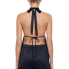 Black halter top with tie details on a white background