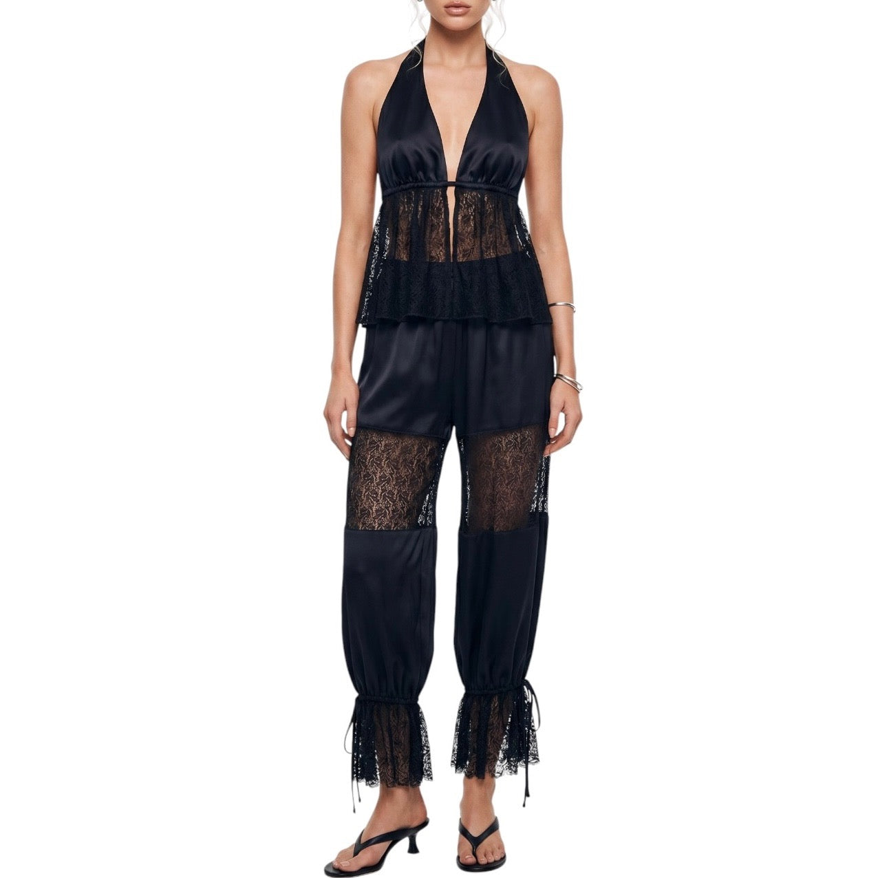 Black lace jumpsuit worn by a model on a white background
