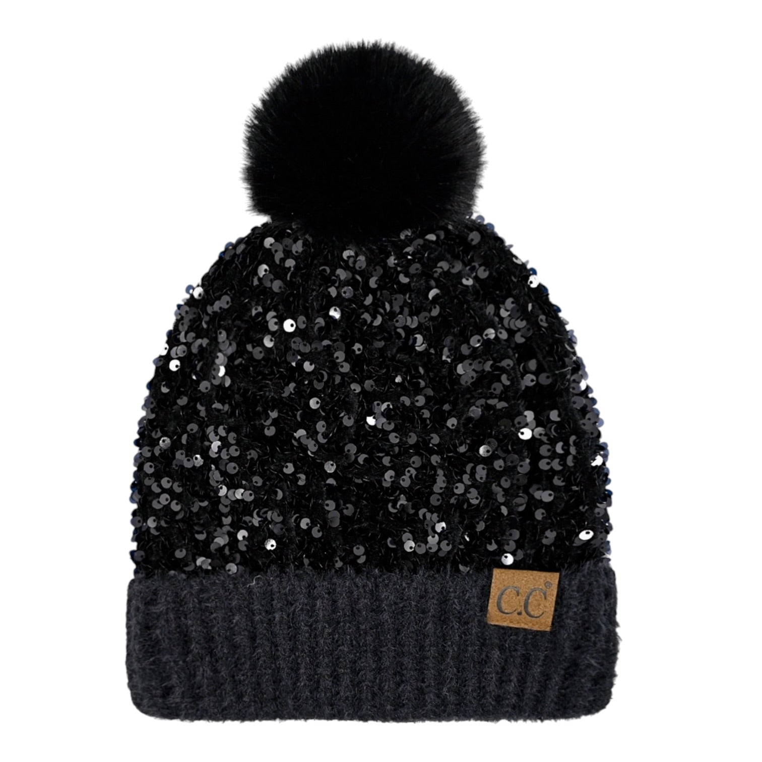 A black beanie hat covered in sequins, featuring a fluffy black pom-pom on top and a dark ribbed cuff with a small tan leather patch showing the letters 'CC'.