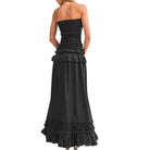 Black strapless gown with ruffled details on a white background