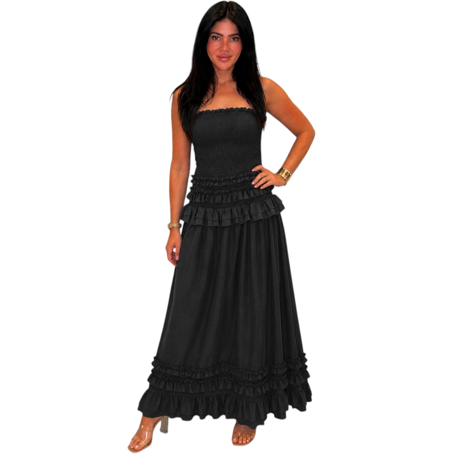 Woman wearing a black strapless dress with ruffles on a white background