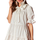 White dress with a bow detail on a white background