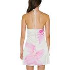White dress with pink floral pattern on a white background