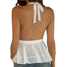 White sheer top with a bow detail on a white background